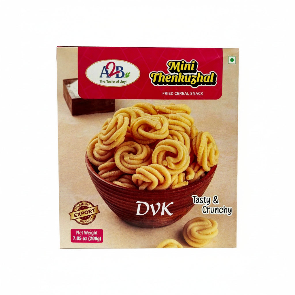 Box of A&B Mini Thenkuzhal fried cereal snack with a bowl of snacks on a wooden surface.