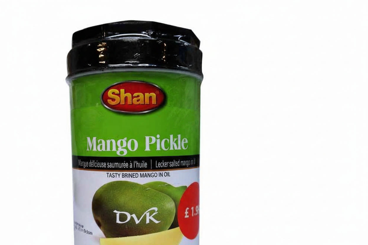 Jar of Shan Mango Pickle with green label and black lid on a white background