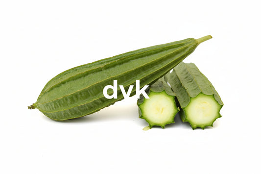 Green okra pods with a cut one on a 
