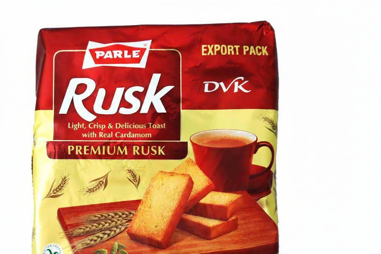Parle Rusk packaging with a cup of tea and cardamom on a white background