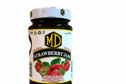 Jar of strawberry jam with a visible brand label on a white background