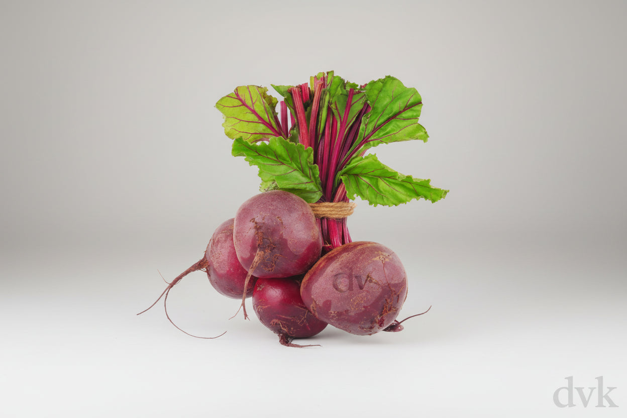 Bunch of beets with green tops on a white background, 