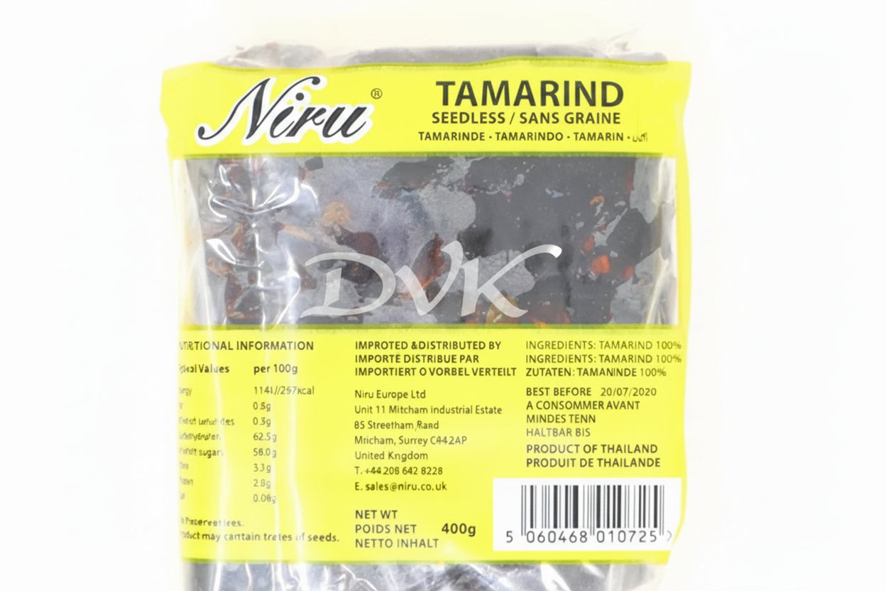 Packaged tamarind seeds with a yellow label on a white background