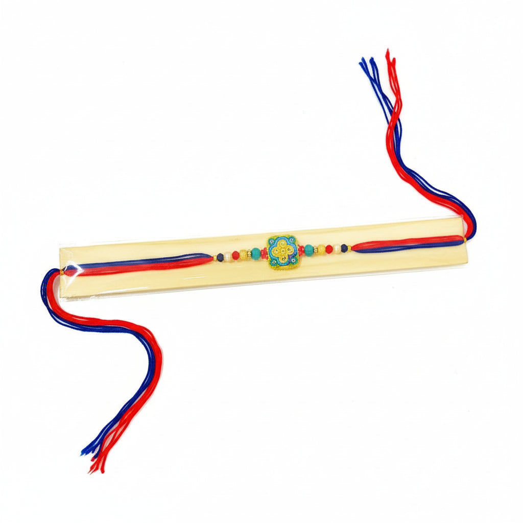 Rakhi with red and blue threads on a white background