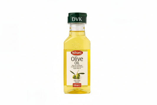Bottle of olive oil with a green cap on a white background